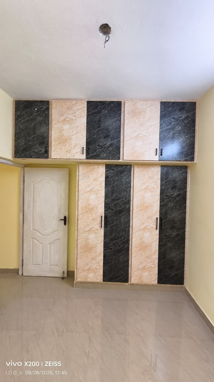 UPVC wardrobe with beige and black marble-effect finish and loft cabinets